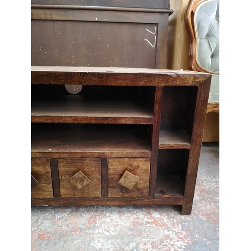 264 - A mango wood TV stand with four lower drawers - approx. 55cm high x 104cm wide x 42.5cm deep