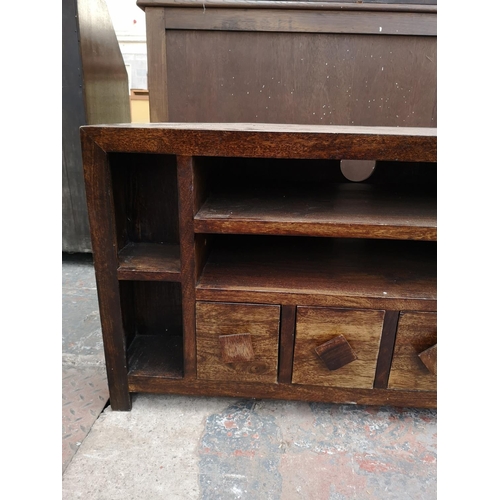 264 - A mango wood TV stand with four lower drawers - approx. 55cm high x 104cm wide x 42.5cm deep