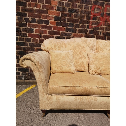 266B - A Regency style beige floral upholstered two piece lounge suite with mahogany supports and brass cas... 