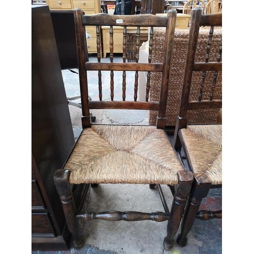 267 - A pair of 18th century style beech and rush seated spindle back farmhouse dining chairs