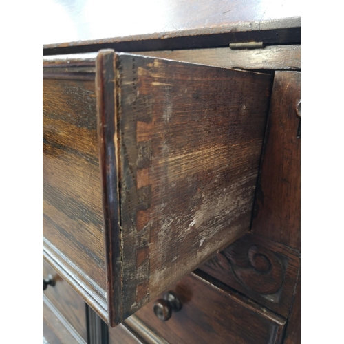 268 - A mid/late 20th century oak bureau with carved floral design, three drawers and fall front - approx.... 