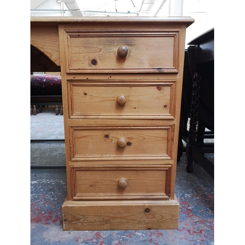 276 - A modern solid pine pedestal desk with five drawers and single cupboard door - approx. 75.5cm high x... 