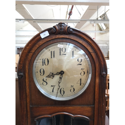 284 - A 1930s oak cased grandfather clock with bevelled glass door, pendulum and three weights - approx. 1... 