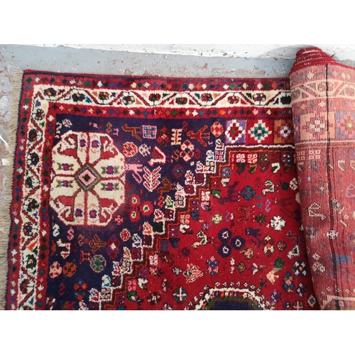 317 - A Persian style red rug - approx. 298cm x 210cm