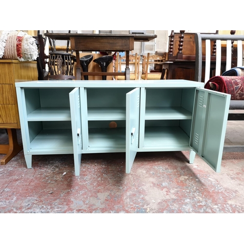 320 - A modern green metal three door cabinet - approx. 58.5cm high x 121cm wide x 40cm deep