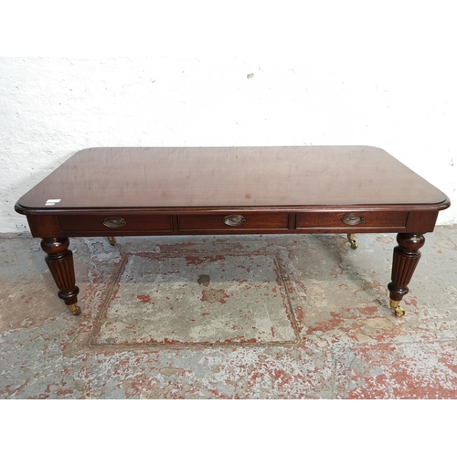 337A - A Regency style mahogany rectangular coffee table with three drawers and brass castors - approx. 48c... 