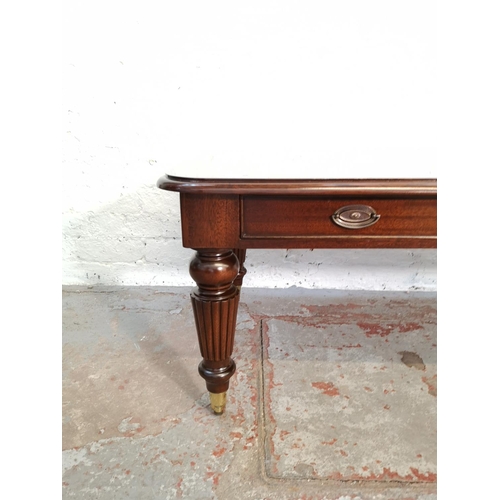 337A - A Regency style mahogany rectangular coffee table with three drawers and brass castors - approx. 48c... 