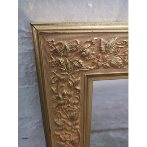 354 - A 19th century style gilt framed wall mirror with foliage design - approx. 90cm wide x 65cm high