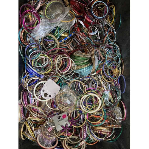 606 - Two boxes containing a large quantity of assorted fashion bangles