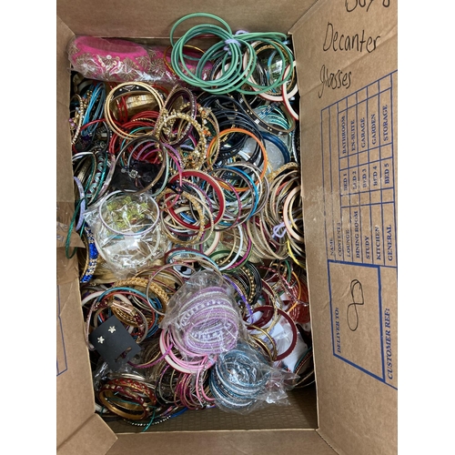 606 - Two boxes containing a large quantity of assorted fashion bangles