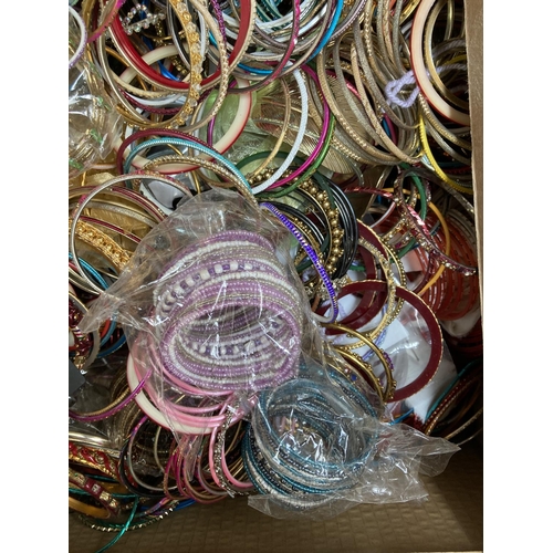 606 - Two boxes containing a large quantity of assorted fashion bangles