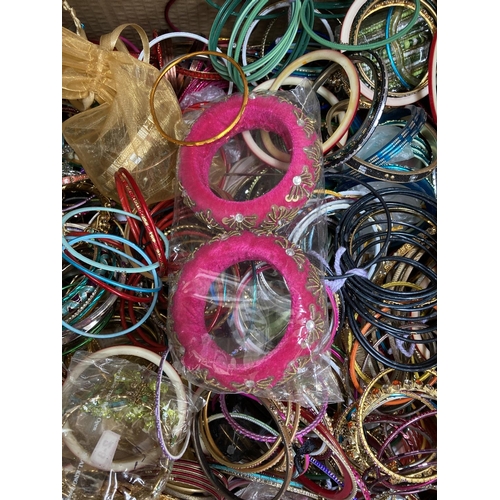 606 - Two boxes containing a large quantity of assorted fashion bangles