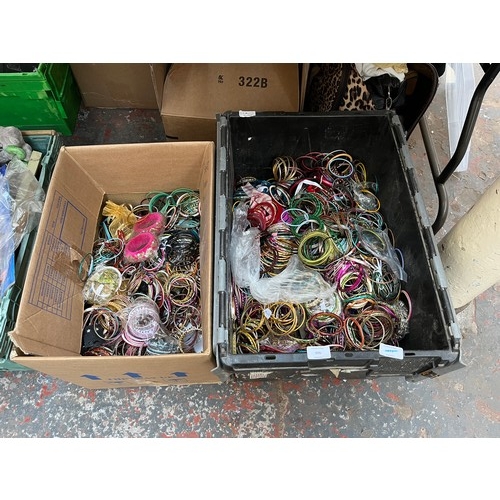 606 - Two boxes containing a large quantity of assorted fashion bangles