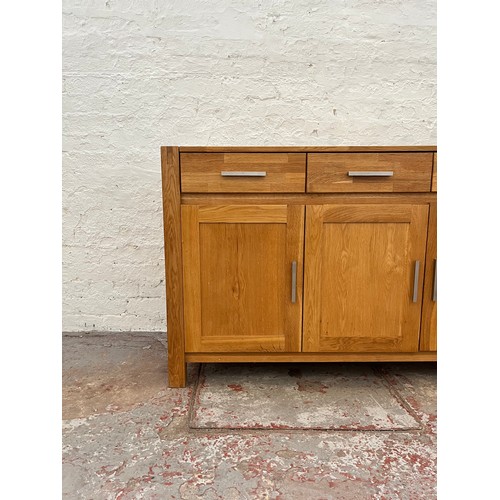 262A - An Arighi Bianchi solid oak sideboard with three drawers and three lower cupboard doors - approx. 86... 