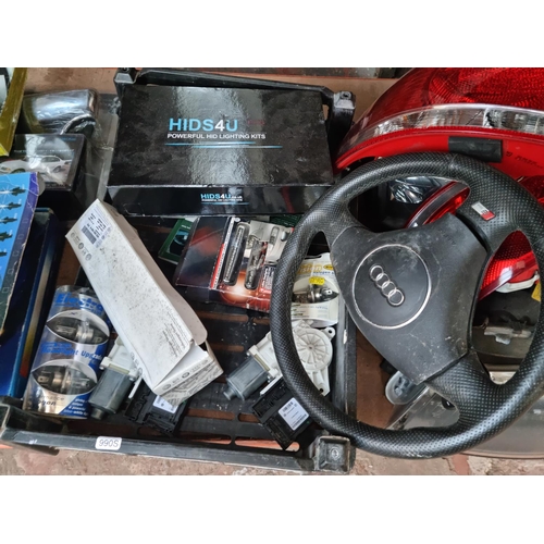 546 - A large collection of various Audi car parts to include S Line steering wheel, boxed Hids 4 U lighti... 