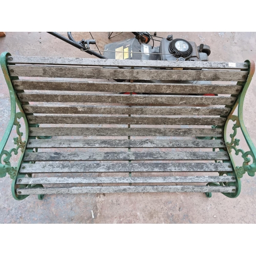 597 - A Victorian style cast iron and wooden slatted two seater garden bench with lions head design - appr... 