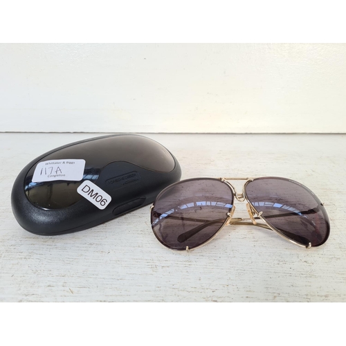 117A - A pair of cased Porsche Design by Carrera gold tone tinted sunglasses