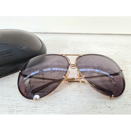 117A - A pair of cased Porsche Design by Carrera gold tone tinted sunglasses