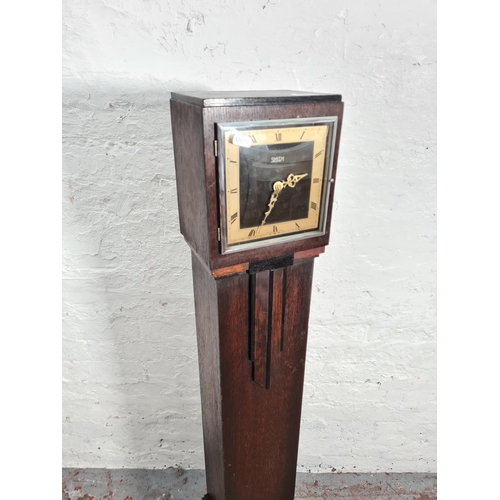 243 - A 1930s Smith Electric oak cased granddaughter clock with later added quartz movement - approx. 137c... 