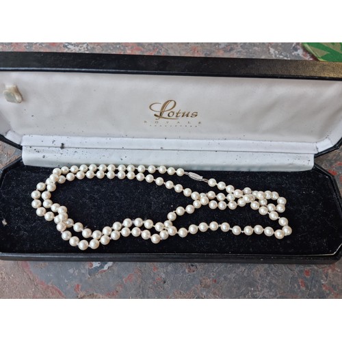 660 - Four boxes containing assorted items to include boxed simulated pearl necklace with 925 silver clasp... 