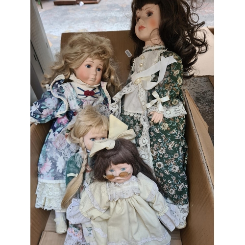 650 - Three boxes containing a large collection of vintage dolls to include Ashton Drake Cute as a Button ... 