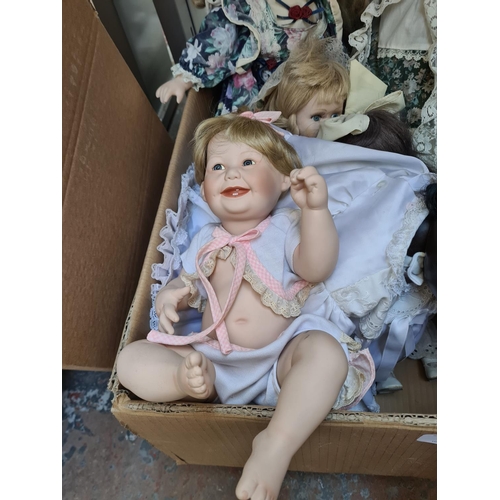 650 - Three boxes containing a large collection of vintage dolls to include Ashton Drake Cute as a Button ... 