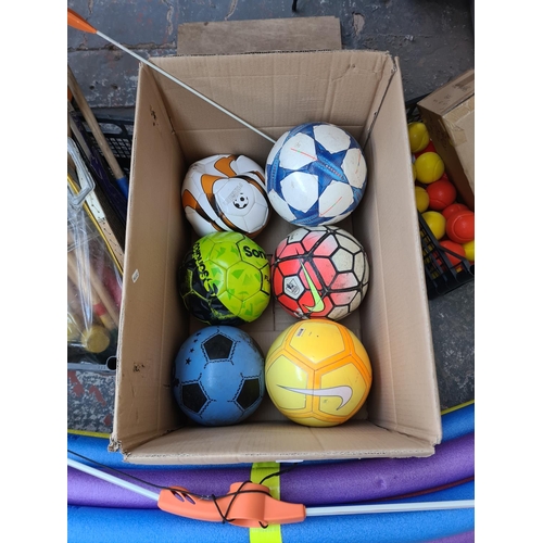 655 - Three boxes containing various sports equipment to include footballs, croquet set, foam noodle float... 