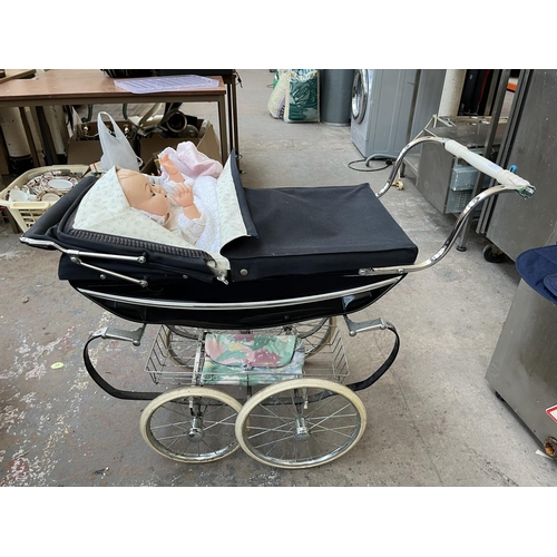 627 - A Silver Cross dolls pram with plastic doll