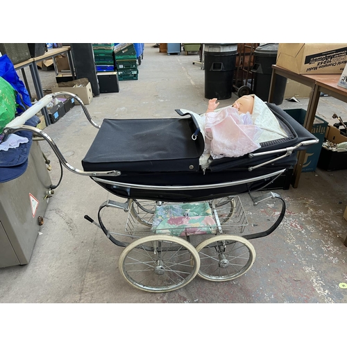 627 - A Silver Cross dolls pram with plastic doll