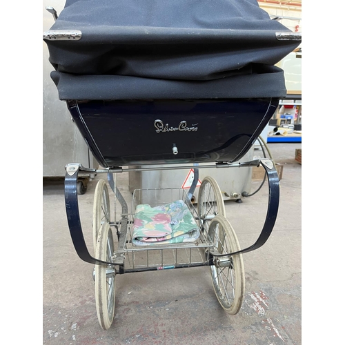 627 - A Silver Cross dolls pram with plastic doll