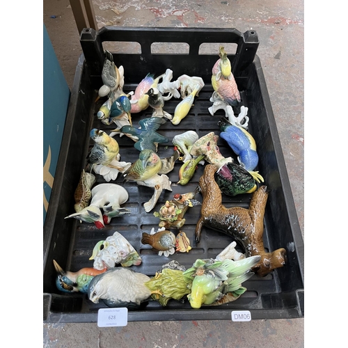 628 - Four boxes containing assorted ceramics to include Wade Whimsies, bird figurines, collectors plates ... 