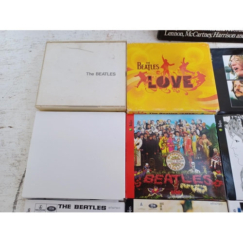 A collection of The Beatles CD albums together with The Complete