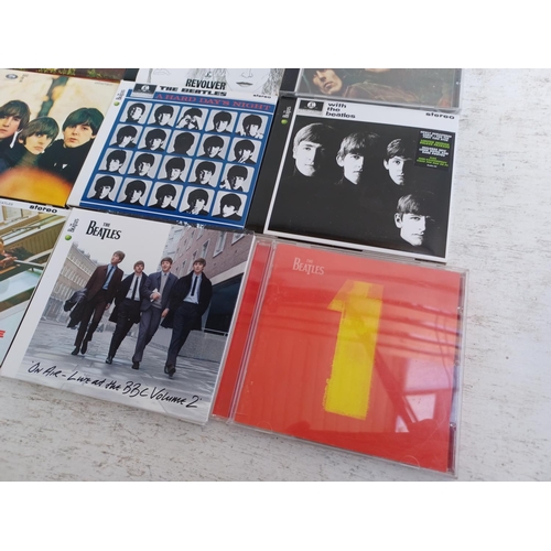 A collection of The Beatles CD albums together with The Complete