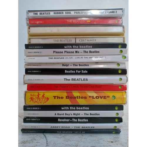 A collection of The Beatles CD albums together with The Complete