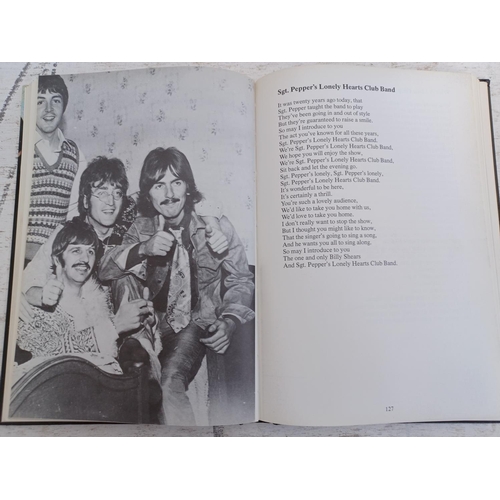 A collection of The Beatles CD albums together with The Complete