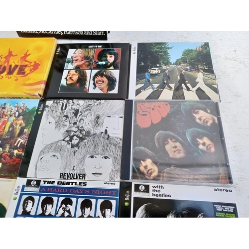 A collection of The Beatles CD albums together with The Complete