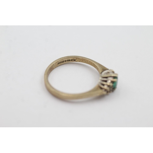 1004 - A hallmarked London 9ct gold emerald and diamond cluster dress ring, size N - approx. gross weight 2... 