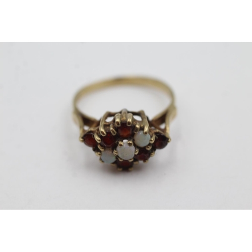 1011 - A 9ct gold opal and garnet dress ring, size P½ - approx. gross weight 3.2 grams