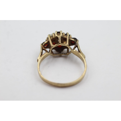 1011 - A 9ct gold opal and garnet dress ring, size P½ - approx. gross weight 3.2 grams