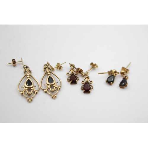 1012 - Three pairs of 9ct gold gemstone drop earrings, two sapphire and one garnet - approx. gross weight 4... 