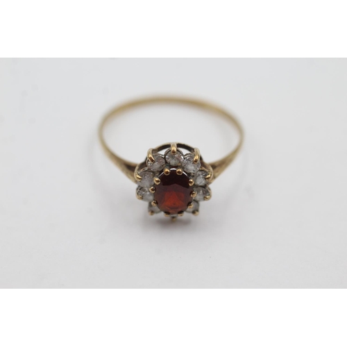 1029 - A hallmarked Birmingham 9ct gold garnet and clear gemstone halo ring, size U½ - approx. gross weight... 