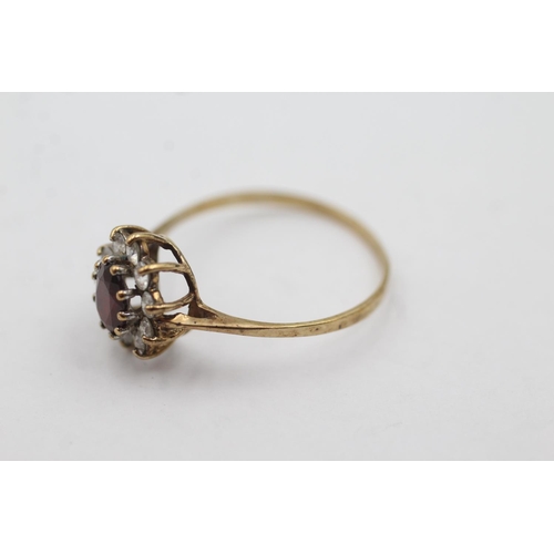 1029 - A hallmarked Birmingham 9ct gold garnet and clear gemstone halo ring, size U½ - approx. gross weight... 