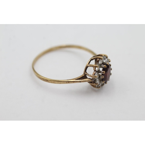 1029 - A hallmarked Birmingham 9ct gold garnet and clear gemstone halo ring, size U½ - approx. gross weight... 