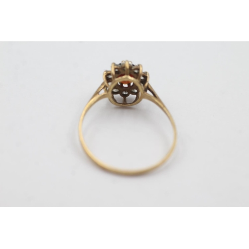 1029 - A hallmarked Birmingham 9ct gold garnet and clear gemstone halo ring, size U½ - approx. gross weight... 