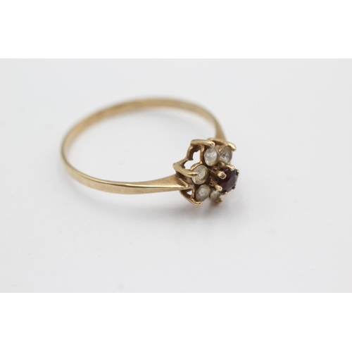 1030 - A 9ct gold garnet and clear gemstone floral cluster ring, size V½ - approx. gross weight 1.6 grams