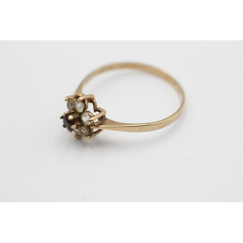 1030 - A 9ct gold garnet and clear gemstone floral cluster ring, size V½ - approx. gross weight 1.6 grams