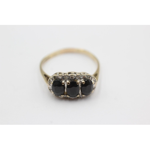 1031 - A 9ct gold sapphire and diamond three stone halo ring, size S - approx. gross weight 2.7 grams