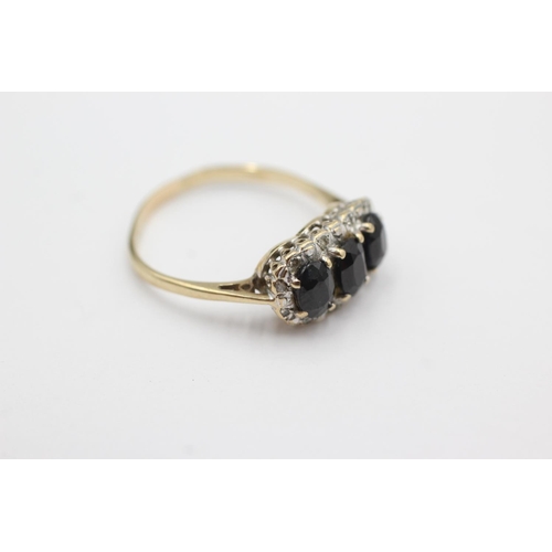 1031 - A 9ct gold sapphire and diamond three stone halo ring, size S - approx. gross weight 2.7 grams