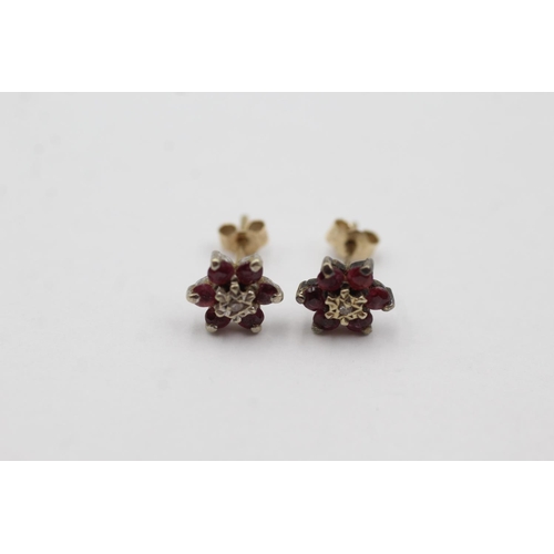 1032 - A pair of 9ct gold diamond and ruby cluster stud earrings - approx. gross weight 0.9 grams