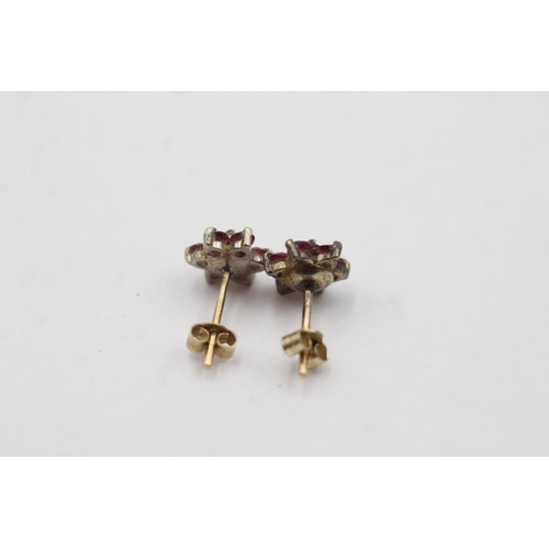 1032 - A pair of 9ct gold diamond and ruby cluster stud earrings - approx. gross weight 0.9 grams